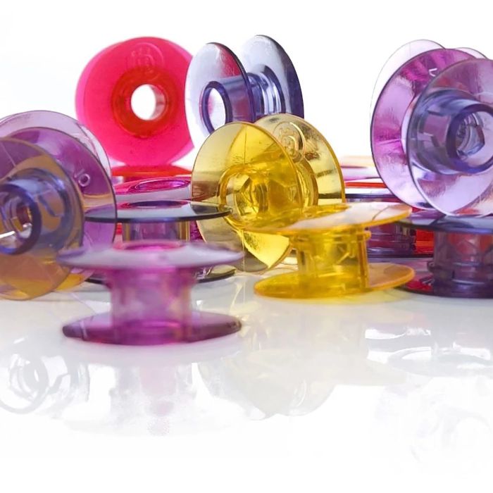 HUSQVARNA® VIKING® Watercolored Bobbins 20-Pack (Pink, Red, Yellow, Dark Blue) - Maple Leaf Quilting Company Ltd.